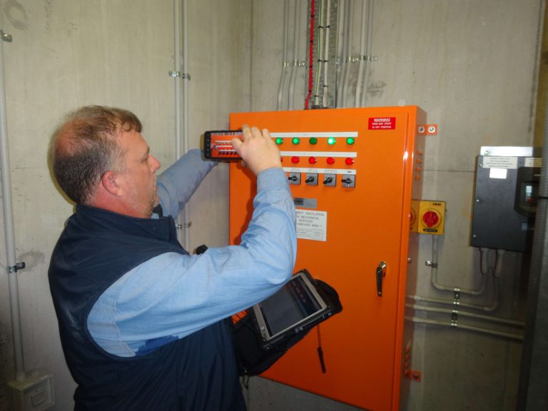 Engineer checking industrial generator fire control system